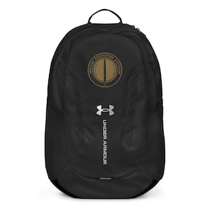 May include: Black Under Armour backpack with a silver logo and a gold embroidered patch that says "Special Activities Division" with a sword inside.