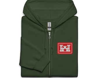 May include: A dark green zip-up hoodie with a red and white castle emblem on the chest. The hoodie has a full-length zip and a hood. The emblem is a rectangular patch.