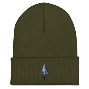 May include: Olive green beanie with a folded brim. The beanie features a blue and white embroidered arrow design on the front. The hat is made of a soft, knitted material.