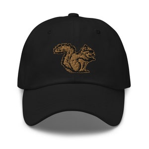 May include: A black baseball cap with an embroidered brown squirrel design.