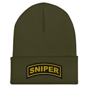May include: A green beanie with a black patch that says "SNIPER" in yellow letters.