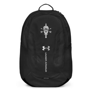 May include: Black Under Armour backpack with a silver skull and crossbones logo and the text "Under Armour" in silver lettering.