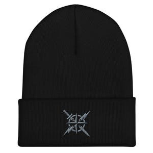 May include: Black beanie with a gray embroidered design featuring a compass rose with crossed swords. The beanie is made of a soft, knitted material and has a folded brim. A stylish and practical accessory for cold weather.