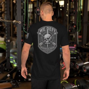 We Defy – Skull & Arrows Warrior Emblem | Echo Valor Elite Series Unisex t-shirt