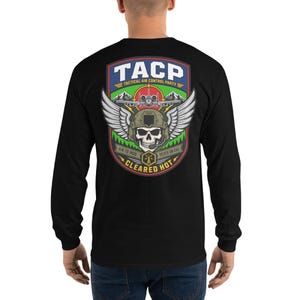 May include: Black long-sleeve shirt with a graphic on the back. The graphic features the text "TACP TACTICAL AIR CONTROL PARTY" above a skull wearing a helmet with wings. The graphic also includes the text "AIR TO MUD" and "DEATH ON CALL".