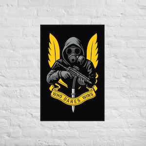 May include: Poster featuring a figure in a gas mask and hooded jacket, holding a rifle. The design includes yellow wings and a banner with the text "WHO DARES WINS" on a black background. A dagger is at the bottom.