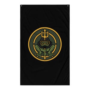 May include: A rectangular black wall flag featuring a circular emblem in the center. The emblem displays a green frog wearing a black diving mask and breathing apparatus, holding a yellow trident. The design is framed by a thick yellow border.