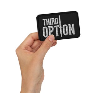 May include: A black embroidered patch with white text that reads "THIRD OPTION" and a white knife graphic.