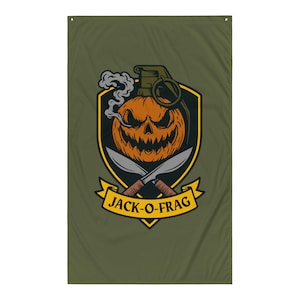 May include: Olive green flag with a Halloween-themed design. It features a carved pumpkin with a smoking fuse, set within a black and yellow shield. Two crossed knives are below the pumpkin, with the text "JACK-O-FRAG" on a yellow banner.