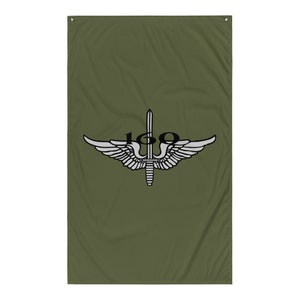 May include: A green flag with a white winged emblem and a black sword with the number "160" on it.