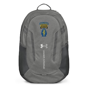 May include: Gray Under Armour backpack with the words "Special Forces Ranger Airborne" and a blue and yellow emblem. The backpack has a top handle, side mesh pockets, and the Under Armour logo.