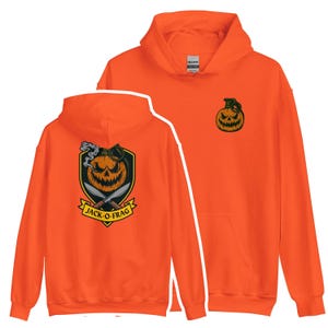 May include: Bright orange hoodie with a pumpkin graphic on the front and back. The front has a small pumpkin design, and the back shows a larger pumpkin with knives and the text "JACK-O-FRAG".
