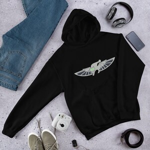 May include: Black hooded sweatshirt with a gray winged creature design. The creature has green eyes and is in a flying pose.