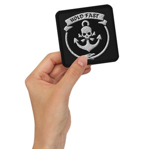 May include: Black embroidered patch with a white anchor, skull and crossbones, and the text "HOLD FAST" on a white banner.