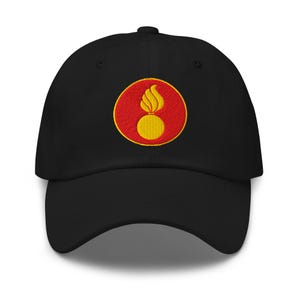 May include: Black baseball cap with a yellow and red embroidered patch. The patch features a yellow flame above a yellow sphere, set against a red circle. The cap has a curved brim and a structured crown.