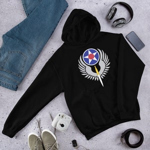 May include: Black hooded sweatshirt with a white and gray graphic of a winged star and a sword. The star has a red center and a blue outer ring.