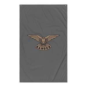 May include: A gray flag featuring a tan eagle emblem with outstretched wings. Below the eagle is the word "RANGER" in a curved banner. The flag is rectangular with a grommet at the top for hanging.