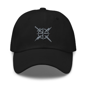 May include: Black baseball cap with a curved brim. The cap features an embroidered design of a compass rose, a sword, and lightning bolts in shades of gray. The cap has a structured fit and a pre-curved visor.