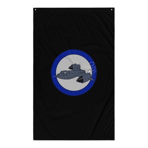 May include: A black flag with a blue circle containing a gray and black SR-71 Blackbird jet in flight. The jet is surrounded by a white circle with a blue outline.