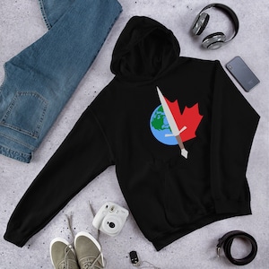 May include: Black hooded sweatshirt featuring a graphic design of a sword piercing a globe with a red maple leaf on top.