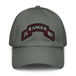 May include: A charcoal gray baseball cap featuring an embroidered patch on the front. The patch is a black curved banner with a red border, displaying the white text 75 RANGER RGT. The cap has a structured crown and a curved brim.