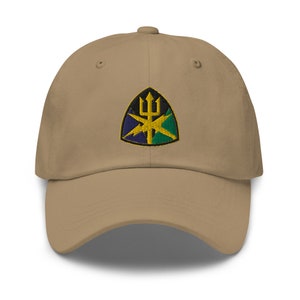 May include: A tan baseball cap with an embroidered patch featuring a green, blue, and yellow shield with a trident and lightning bolts.
