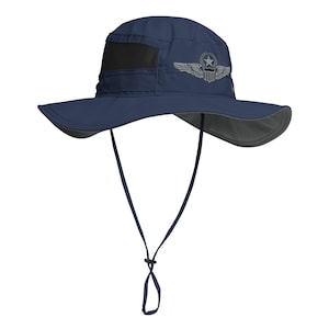 May include: A navy blue sun hat with a black mesh panel and a gray embroidered pilot wing patch with a star and a shield. The hat has a chin strap.