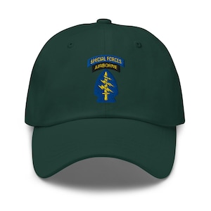 May include: A dark green baseball cap with a curved brim. The cap features an embroidered patch with the words "SPECIAL FORCES AIRBORNE" above a blue and yellow arrowhead design. The cap is a classic, adjustable style.