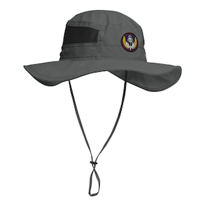 May include: A gray sun hat with a wide brim and a black mesh vent. The hat features a round patch with a skull and wings design. It has an adjustable chin strap for a secure fit.