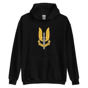 May include: Black hooded sweatshirt with a front pocket and a drawstring hood. The sweatshirt features a yellow and silver emblem with a sword and the words "WHO DARES WINS".