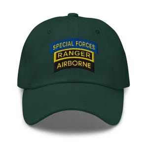May include: A dark green baseball cap with a curved brim. The cap features embroidered text in yellow and white that reads "SPECIAL FORCES RANGER AIRBORNE" on a patch.