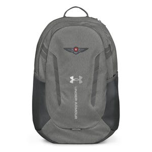 May include: Gray Under Armour backpack with a top handle and side mesh pockets. The backpack features the Under Armour logo and a design on the front. The word "STORM" is printed at the bottom.