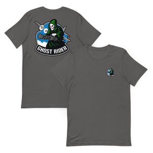 May include: Two charcoal gray t-shirts. One shirt features a large graphic of a grim reaper with a machine gun, the text "GHOST RIDER" in a white font. The other shirt has a smaller version of the same graphic on the chest.