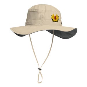 May include: A beige sun hat with a wide brim and a dark gray underside. The hat features a mesh panel and a decorative emblem with gold and red accents. It has an adjustable chin strap.