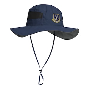 May include: A navy blue sun hat with a wide brim and a black mesh panel. The hat has a patch with a white bird and the text "GREENHORNS FLIGHT" in yellow.