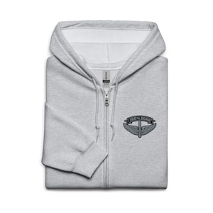 May include: A light gray zip-up hooded sweatshirt with a small embroidered emblem on the chest. The emblem features the text "160th SOAR" above a stylized wing and arrow design. The sweatshirt has a full zipper and a hood.