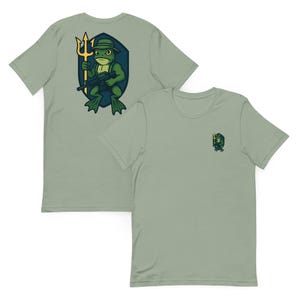 May include: Two light green t-shirts. One shirt features a large graphic of a frog holding a trident and a rifle, wearing a hat, and standing in front of a shield. The other shirt has a smaller version of the frog graphic on the chest.