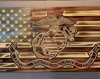 May include: A wooden American flag with the Marine Corps emblem in the center. The flag is distressed and has a blue and white color scheme. The words "Honor", "Courage", and "Commitment" are written on the flag.