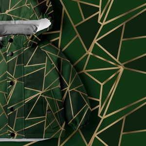 May include: A green hooded jacket with a geometric pattern of gold lines. The jacket has a zipper closure and two pockets.