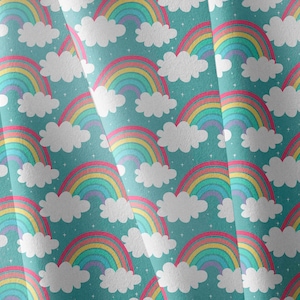 May include: A fabric featuring a repeating pattern of colourful rainbows and fluffy white clouds on a teal background. The rainbows have red, orange, yellow, green, blue, and purple arches. Small white stars are scattered throughout.