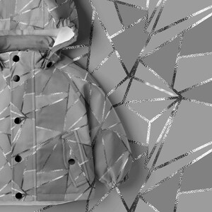 May include: A light gray hooded jacket featuring a reflective silver geometric pattern of intersecting lines. The jacket includes a front placket with dark circular snap buttons and two front pockets with matching snap closures on the flaps.