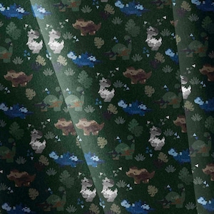 May include: A dark green fabric featuring a repeating pattern of pixelated dinosaurs in shades of blue, brown, and grey. The design includes small white triangular accents and stylised leaf shapes scattered throughout the dark green background.