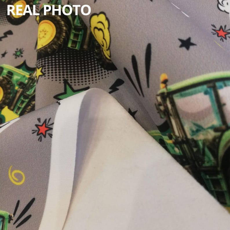 a close up of a fabric with a tractor on it