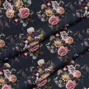 May include: A dark navy blue fabric featuring a dense floral print. The pattern consists of various blooming flowers in shades of dusty pink, soft purple, and cream, interspersed with thin, dark stems and small, muted green leaves throughout.