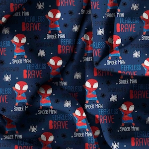 May include: A dark blue fabric featuring a repeating pattern of cartoon Spider-Man characters, white spider icons, and the text "SPIDER MAN", "FEARLESS", and "BRAVE" in red and light blue lettering across the surface of the material.