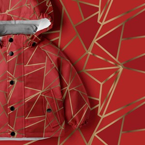 May include: A red hooded jacket featuring a geometric pattern of thin gold lines. The jacket has a front placket with black snap buttons, a hood with a white interior lining, and two front pockets. The design consists of angular shapes.
