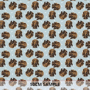 May include: A seamless pattern featuring brown dachshund dog faces on a light blue background with white bone shapes.  The pattern is 50cm wide.