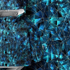 May include: A hooded jacket featuring a geometric pattern of blue and black triangles with thin gold lines. The fabric displays a deep space-inspired aesthetic with varying shades of teal and navy. The jacket includes a hood and black buttons.