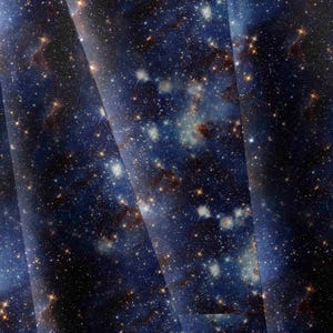 May include: A fabric featuring a deep space galaxy print with a dark blue and black background. The pattern displays a dense field of bright white and golden yellow stars, along with soft, hazy nebulae in shades of brown and dark blue.