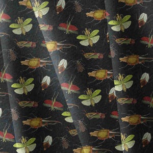 May include: A dark fabric featuring a repeating pattern of various insects including green mantises, brown beetles, and red-winged grasshoppers. The detailed illustrations are scattered across the black background in a dense, organised arrangement.